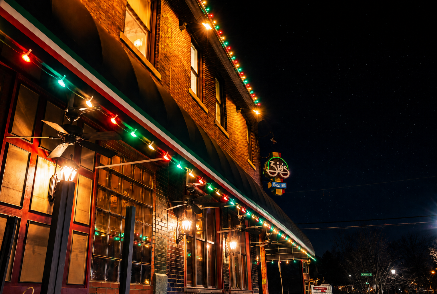 Zio's on The Hill restaurant with red and green C9 lights along the awning