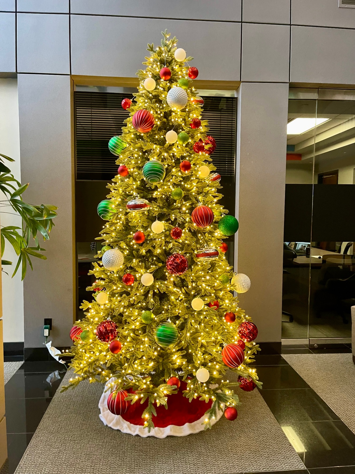 Large decorated interior Christmas tree installed in a St. Louis office lobby