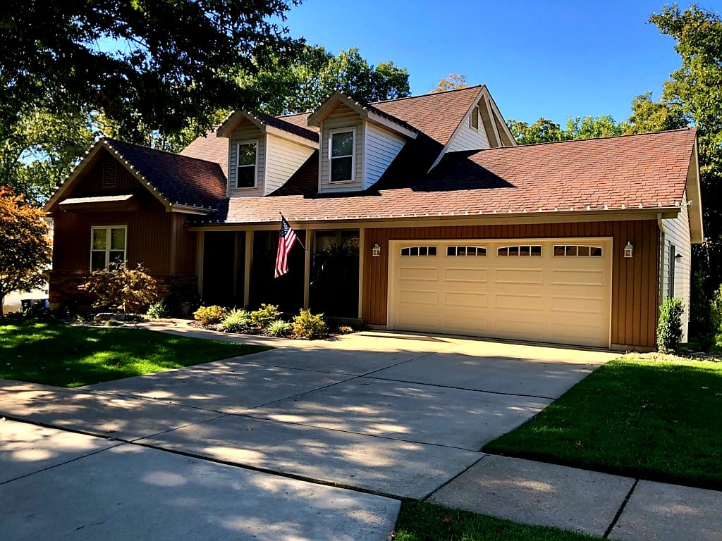 Daytime view of clean Christmas light install on a craftsman home